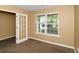 Bright home office space with natural light, neutral walls, a window and a glass panel door at 4678 Ravenwood Loop, Union City, GA 30291