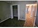 Bedroom with carpet, closet, and access to the hallway featuring three doors at 745 Queen Ann Ct, Stone Mountain, GA 30083