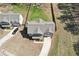 Aerial view of gray two-story home with an attached garage, concrete driveway, and mature trees at 780 Mccart Rd, Lawrenceville, GA 30045
