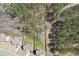Aerial view of the home and lot showing mature trees, a wooden fence, and surrounding neighborhood at 780 Mccart Rd, Lawrenceville, GA 30045