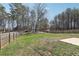 Sprawling backyard featuring a lush lawn, bordered by a wooden fence and mature trees at 780 Mccart Rd, Lawrenceville, GA 30045