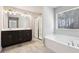 Spacious primary bathroom with a double vanity, shower and separate soaking tub at 780 Mccart Rd, Lawrenceville, GA 30045