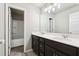 Bathroom featuring double sink vanity with dark wood cabinets and a full bathtub and shower at 780 Mccart Rd, Lawrenceville, GA 30045