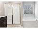 Bright bathroom featuring a soaking tub, stand up shower and dark wood cabinets at 780 Mccart Rd, Lawrenceville, GA 30045