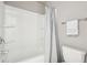 Bright bathroom shows a bathtub with shower, and a nearby toilet with silver hardware at 780 Mccart Rd, Lawrenceville, GA 30045