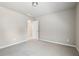 Bright, neutral bedroom with plush gray carpeting, a window and a connecting door to the bathroom at 780 Mccart Rd, Lawrenceville, GA 30045