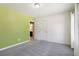 Bedroom features a light green accent wall, a neutral color scheme, and access to the attached bathroom at 780 Mccart Rd, Lawrenceville, GA 30045