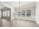 Dining area with light wood floors and large windows providing natural light at 780 Mccart Rd, Lawrenceville, GA 30045