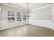 Open dining area with three large windows, chair railing, and modern light fixture at 780 Mccart Rd, Lawrenceville, GA 30045