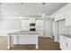Modern kitchen featuring an island with granite countertops, white cabinets, and stainless steel appliances at 780 Mccart Rd, Lawrenceville, GA 30045