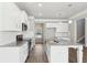 Modern kitchen featuring white cabinets, stainless appliances, and a granite countertop island with pendant lighting at 780 Mccart Rd, Lawrenceville, GA 30045