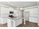 Bright kitchen featuring granite counters, white cabinets, stainless steel appliances, and a stylish pendant lighting at 780 Mccart Rd, Lawrenceville, GA 30045