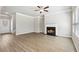 Comfortable living room featuring wood-look floors, a fireplace, and abundant natural light streaming through the windows at 780 Mccart Rd, Lawrenceville, GA 30045