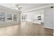 Open-concept living area with wood-look floors, connects the living room and kitchen, brightened by natural light at 780 Mccart Rd, Lawrenceville, GA 30045