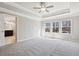 Main bedroom with carpet and large windows, leading into the en-suite bathroom at 780 Mccart Rd, Lawrenceville, GA 30045