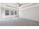 Spacious main bedroom with tray ceiling, ceiling fan, and three large windows at 780 Mccart Rd, Lawrenceville, GA 30045