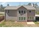 Two-story home with gray siding, many windows, green grass and a concrete patio at 780 Mccart Rd, Lawrenceville, GA 30045