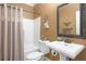 Bathroom with a standalone sink and tiled tub and shower combo at 1967 Mason Mill Rd, Decatur, GA 30033