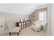 Cozy bedroom features a chair, ottoman, shelving unit, and window at 1967 Mason Mill Rd, Decatur, GA 30033