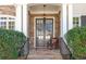 Inviting front entrance featuring double doors, stone accents, and a cozy chair at 1967 Mason Mill Rd, Decatur, GA 30033