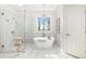Spa-like main bathroom with freestanding tub, frameless shower, and elegant marble surround at 1967 Mason Mill Rd, Decatur, GA 30033