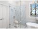 Beautiful main bathroom with walk-in glass shower and soaking tub next to a large window at 1967 Mason Mill Rd, Decatur, GA 30033