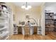 Bright home office with a white desk, storage drawers, and open shelving for organized storage at 1967 Mason Mill Rd, Decatur, GA 30033