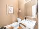Stylish powder room with pedestal sink, framed art, and decor creating a sophisticated space at 1967 Mason Mill Rd, Decatur, GA 30033
