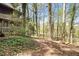 Lush backyard featuring a screened porch, surrounded by tall trees and greenery at 4 Quail Run, Decatur, GA 30035