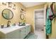 Bathroom featuring dual sinks, modern lighting, and a glass door shower for a spa-like experience at 4 Quail Run, Decatur, GA 30035