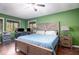 Bedroom with green walls and wood floors, including ceiling fan, furnishings, and window views at 4 Quail Run, Decatur, GA 30035