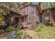 Charming multi-level townhome with rustic wood siding and inviting front porch and wooded surroundings at 4 Quail Run, Decatur, GA 30035