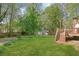 Expansive backyard with lush green grass, mature trees, and a storage shed at 567 Shiloh Nw Rd, Kennesaw, GA 30144