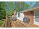 Relaxing backyard deck complete with outdoor seating and a grill for summer barbecues at 567 Shiloh Nw Rd, Kennesaw, GA 30144