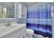 Light and airy bathroom featuring a sink with updated fixtures and a blue-striped shower curtain at 567 Shiloh Nw Rd, Kennesaw, GA 30144