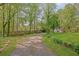 Long gravel driveway leading to a property with a well-maintained lawn at 567 Shiloh Nw Rd, Kennesaw, GA 30144