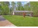 Lovely single-story home with a long drive and a lush front yard and landscaping at 567 Shiloh Nw Rd, Kennesaw, GA 30144