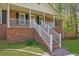 Beautiful brick home with a well-manicured lawn, complemented by white railings and landscaping at 567 Shiloh Nw Rd, Kennesaw, GA 30144