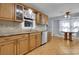 Stylish kitchen showcasing wooden cabinets, granite countertops, stainless appliances, and tile backsplash at 567 Shiloh Nw Rd, Kennesaw, GA 30144