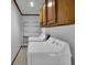 Laundry room with wood cabinets, shelving, and washer/dryer at 567 Shiloh Nw Rd, Kennesaw, GA 30144