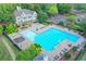 Large community pool with multiple lounge chairs, tables with umbrellas, and a clubhouse at 973 Meadow Club Ct, Suwanee, GA 30024