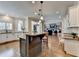 Open kitchen layout with an island, stone countertops, and stainless steel appliances at 973 Meadow Club Ct, Suwanee, GA 30024