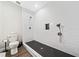 Modern bathroom featuring a stand up shower, black tile floor, and subway tile surround at 1599 Benham Dr, Snellville, GA 30078