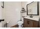 Charming half-bath with shiplap walls, and a rustic vanity with modern fixtures at 1599 Benham Dr, Snellville, GA 30078