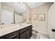 Bright bathroom with dark wood vanity, white countertop, and decorative wall art at 1599 Benham Dr, Snellville, GA 30078