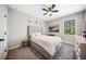 Bedroom featuring neutral paint, tufted headboard, ceiling fan and natural light from the window at 1599 Benham Dr, Snellville, GA 30078