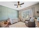 Charming Bedroom with a crib, accent wall, and comfortable seating area at 1599 Benham Dr, Snellville, GA 30078
