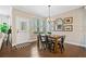 Warm dining area features hardwood flooring, a wooden table, bench seating, and backyard views at 1599 Benham Dr, Snellville, GA 30078