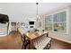 Dining area with hardwood flooring, a wooden table and bench seating, and backyard views at 1599 Benham Dr, Snellville, GA 30078