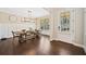 Elegant dining room with wood floors, wainscoting, a modern light fixture, and a large window at 1599 Benham Dr, Snellville, GA 30078